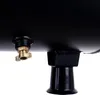 A close-up view of the bottom of a black air compressor tank, showing a brass drain valve and a black support leg. Produktbild-Vorschau