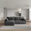 A modern living room with a sectional sofa, kitchen in the background, and a floor lamp. Produktbild-Vorschau