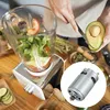 A person is preparing food, with a blender and various ingredients on a wooden table. A small motor is shown in a circular overlay. Produktbild-Vorschau
