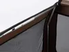 A close-up view of the corner of a brown dog crate, showing the metal frame and mesh fabric. Produktbild-Vorschau