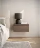 A modern bedroom scene featuring a floating nightstand with a lamp and books. Produktbild-Vorschau