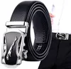A black leather belt with a silver jaguar buckle is displayed prominently. The belt is coiled and the buckle is shown in detail. A portion of a person wearing the belt is visible in the background. Anteprima dell’immagine prodotto
