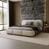 A modern bedroom with a large bed, stone accent wall, and large window. Produktbild-Vorschau