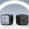 Two black cube-shaped power strips are displayed on a light gray and white background. Produktbild-Vorschau