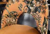 Close-up of the back of an orange velvet chair with a floral pattern. Produktbild-Vorschau