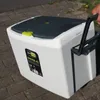 A person is pulling a white cooler with a gray handle on a brick pathway. Produktbild-Vorschau
