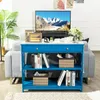 A blue console table with shelves and a drawer, placed in a living room setting next to a sofa, with a TV and decorative items on top. Náhľad obrázku produktu