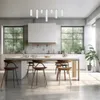A modern kitchen with a large island and stools, illuminated by natural light from large windows. Produktbild-Vorschau
