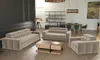 A modern living room with a beige sofa set, coffee table, and bookshelf. Produktbild-Vorschau
