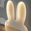 A close-up shot of a bunny ear-shaped night light, illuminated from behind. Produktbild-Vorschau