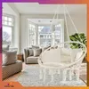 A living room with a hanging chair, sofa, and rug. Voir les images du produit