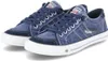 A pair of blue canvas sneakers with white laces and soles, shown from a slightly elevated side angle against a white background. Voir les images du produit