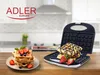 A waffle maker with waffles and strawberries on a kitchen counter. Anteprima dell’immagine prodotto