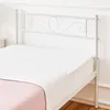 A white metal bed frame with a white mattress and a pink blanket. Podgląd zdjęcia produktu