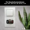 A black USB-C charger with an LED display plugged into a white wall socket, next to a snake plant. Produktbild-Vorschau