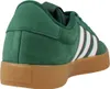 A close-up side view of a green Adidas sneaker with white stripes and a brown sole. Produktbild-Vorschau