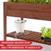 A wooden raised garden bed with a shelf holding gardening tools and plants. Produktbild-Vorschau