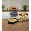 A waffle maker and two bubble waffles are displayed on a wooden countertop in a kitchen setting. Produktbild-Vorschau