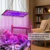 A grow light illuminates plants in a room with a bookshelf and chair in the background. Náhľad obrázku produktu