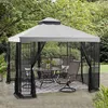 A gazebo with outdoor furniture and mosquito netting set up on a patio. Voir les images du produit