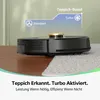 A robot vacuum cleaner transitioning from a wooden floor to a carpet, with an overlay illustrating its 'Standard' and 'Turbo' modes. Produktbild-Vorschau