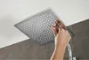 A hand is shown cleaning or adjusting a shower head. Produktbild-Vorschau