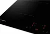 A close-up, angled view of a black induction hob. Anteprima dell’immagine prodotto