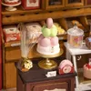 A miniature bakery display with various sweets and pastries. Anteprima dell’immagine prodotto