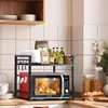 A kitchen counter with a microwave oven on a shelf organizer, along with various kitchen items. Produktbild-Vorschau