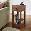 A wooden side table next to a sofa in a living room. Náhled obrázku produktu