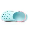 A single light blue Crocband clog with a pink strap is shown from a side view against a white background. Produktbild-Vorschau