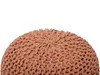 A close-up of a round, knitted pouf. Produktbild-Vorschau