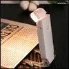 A white LED book light is clipped to a newspaper, illuminating the text. Náhľad obrázku produktu