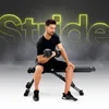 A man is performing bicep curls with a dumbbell while sitting on a black weight bench. The background features a large, glowing yellow text that reads "Stride" and has a smoky effect. Podgląd zdjęcia produktu