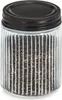 A clear studio shot of a glass storage jar with a black metal lid, filled with small dark items. Náhled obrázku produktu