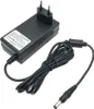A black AC-DC adapter with a European plug and a coiled cable with a barrel connector. Podgląd zdjęcia produktu