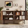 A wooden sideboard with open doors, displaying books and decorative items, in a well-lit room. Anteprima dell’immagine prodotto