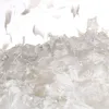 A close-up view of loose, shredded white material, resembling artificial snow. Voir les images du produit