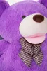 Close-up of a large purple teddy bear's face and chest, wearing a plaid scarf. Náhľad obrázku produktu