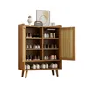 A wooden shoe cabinet with rattan doors and shelves, displayed against a white background. Produktbild-Vorschau