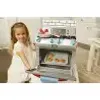 A young girl is playing with a toy kitchen oven. Anteprima dell’immagine prodotto
