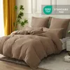 A bed with musselin bedding in a bedroom setting. Produktbild-Vorschau