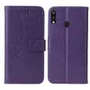 A purple flip cover phone case with a floral and butterfly embossed design is shown from the front and back. Produktbild-Vorschau