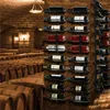 A wine cellar with rows of wine barrels and a wall-mounted wine rack displaying various bottles of wine. Produktbild-Vorschau