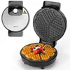 A waffle maker is shown open with a freshly made heart-shaped waffle topped with berries and cream. Produktbild-Vorschau