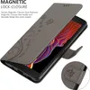 A grey flip case for a smartphone, with a floral pattern, is shown open, revealing the phone screen. Náhľad obrázku produktu