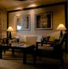 A living room scene with a sofa, coffee table, and lamps. Náhled obrázku produktu