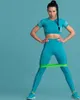 A woman is performing a leg exercise with a resistance band around her thighs. Produktbild-Vorschau