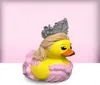A 3D render of a Glinda the Good Witch themed rubber duck, wearing a crown and a pink dress, against a pink gradient background. Náhled obrázku produktu