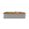 A loaf of bread in a baking pan, shown from the side against a white background. Voir les images du produit